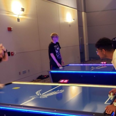 Playing Air Hockey on LED Table at College Event