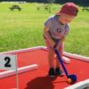 Portable Mini Golf Course Rental with Red Turf at Customer Appreciation Event