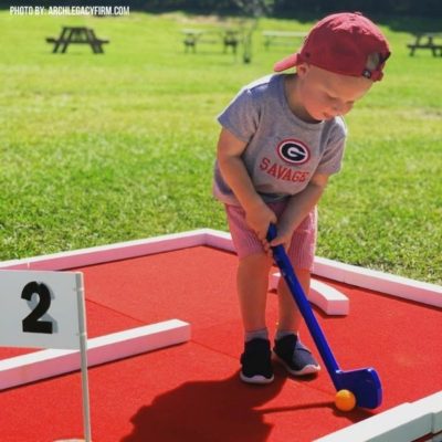 Portable Mini Golf Course Rental with Red Turf at Customer Appreciation Event