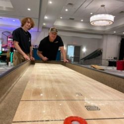 Testing 9ft Shuffleboard Tables at Sales Meeting Event